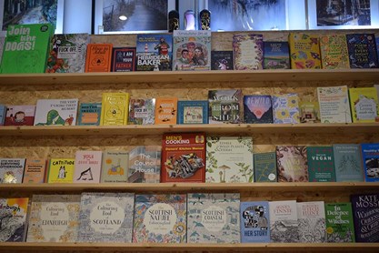 a wall of books on cork shelving