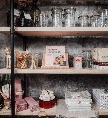 Products lined up on shelves inside a shop.