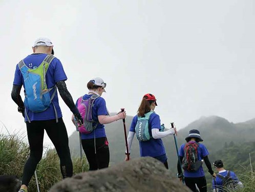 Group of people hiking in single file