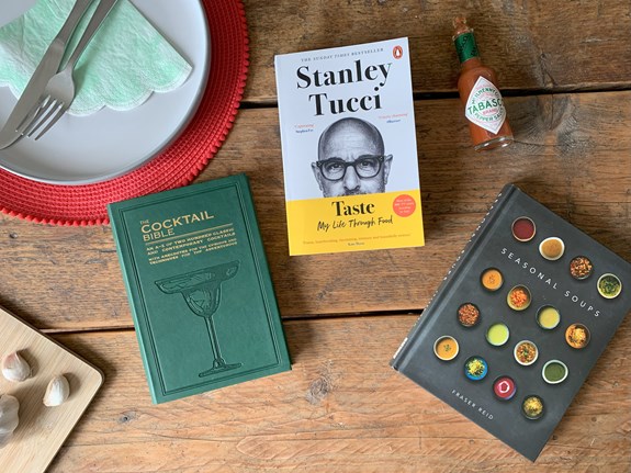 Food books spread out on a dinner table