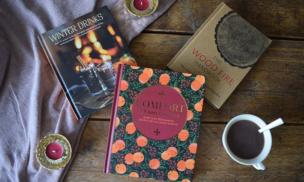 Books spread out on a table and a blanket