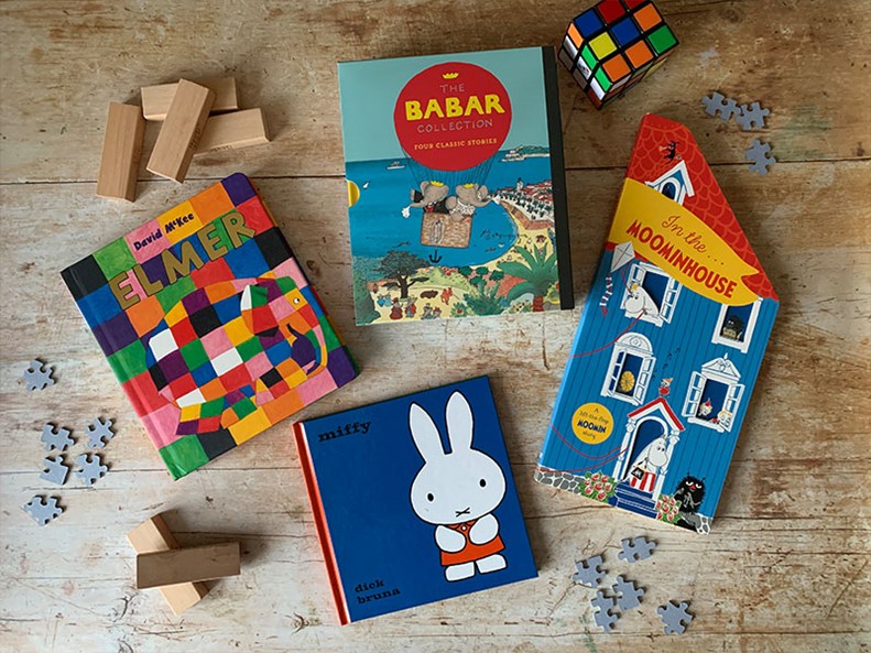 Vintage children's books spread out on a wooden surface